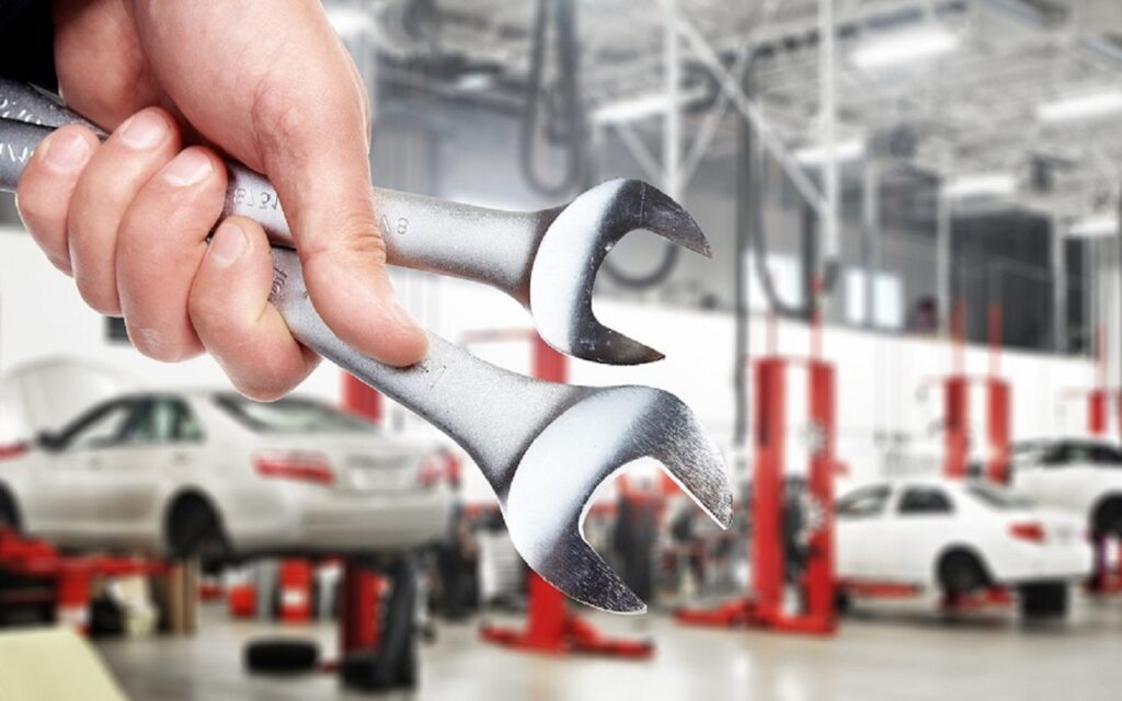 Hand with wrench. Auto mechanic.